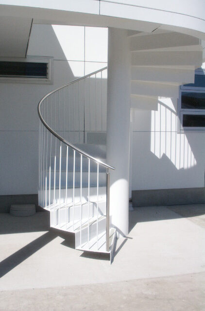 Custom white outdoor spiral staircase Stainless steel handrail - Elliott Engineering
